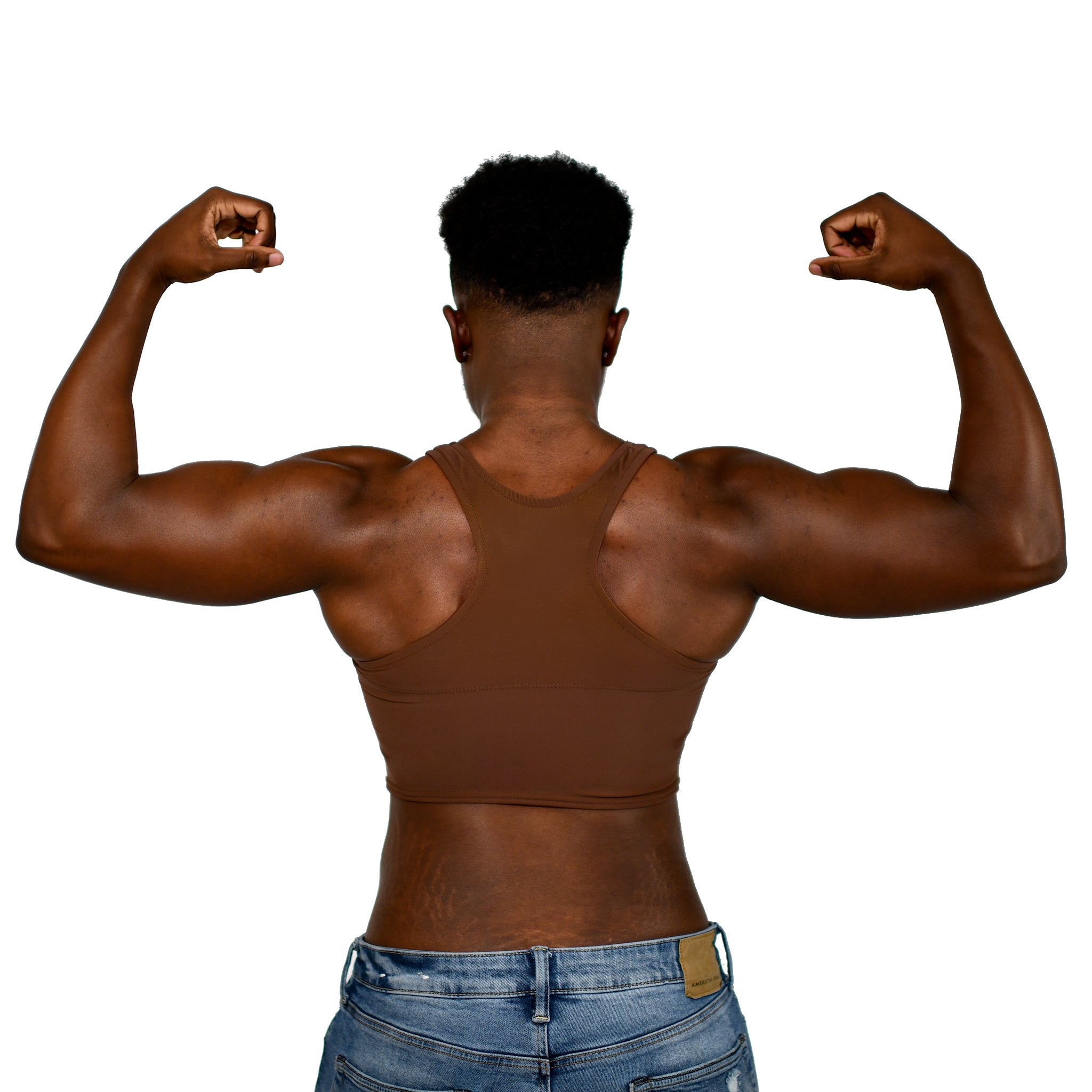 Model shows off a Nude No. 1 racerback binder, back to the viewer and flexing both arms.